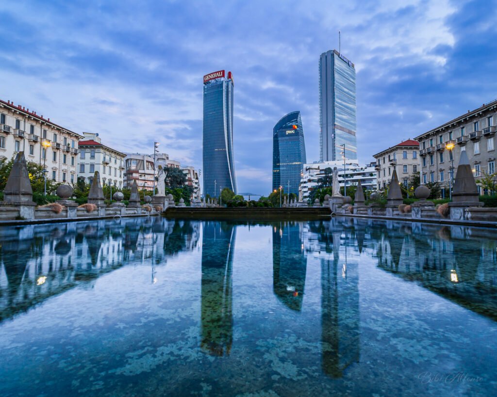 Long exposure shot of the Fontana delle Quattro Stagioni in Milan’s modern CityLife district, with cool blue tones reflecting the interplay of water, architecture, and urban movement.